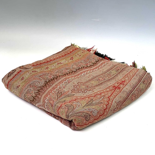 2801 - A Victorian paisley wool shawl with harlequin fringe, 332cm x 160cm.