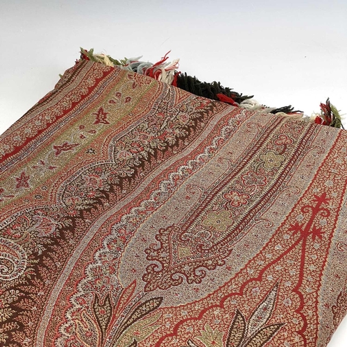 2801 - A Victorian paisley wool shawl with harlequin fringe, 332cm x 160cm.