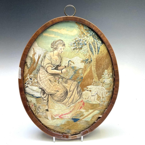 2803 - A Regency silk work oval picture of a shepherdess preparing a wreath, with painted detail, mahogany ... 