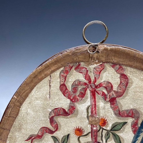 2803 - A Regency silk work oval picture of a shepherdess preparing a wreath, with painted detail, mahogany ... 