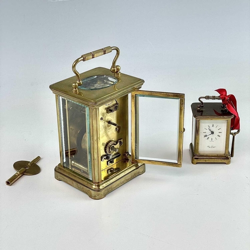 2901 - A miniature Swiss brass carriage timepiece, 20th century, by M Norman, height 6.5cm, together with a... 