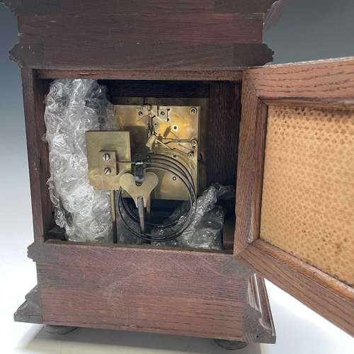 2903 - A German Winterhalder and Hofmeier oak architectural bracket clock, with turned finials and matt bra... 