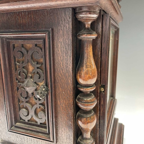 2903 - A German Winterhalder and Hofmeier oak architectural bracket clock, with turned finials and matt bra... 
