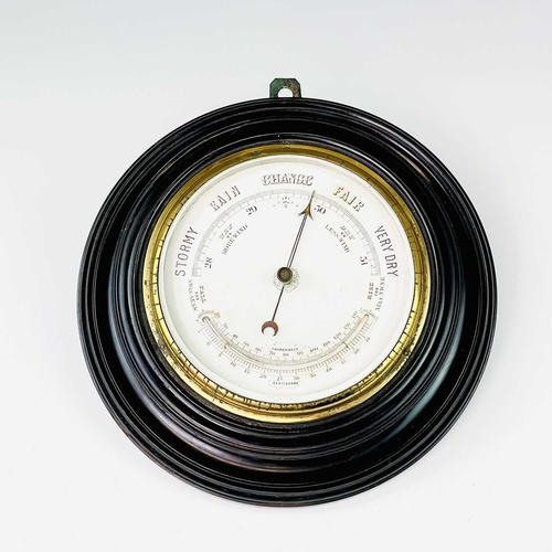 2907 - A late Victorian aneroid circular barometer, with white ceramic dial and ebonised case, diameter 28c... 