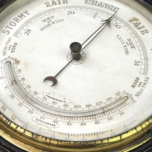 2907 - A late Victorian aneroid circular barometer, with white ceramic dial and ebonised case, diameter 28c... 