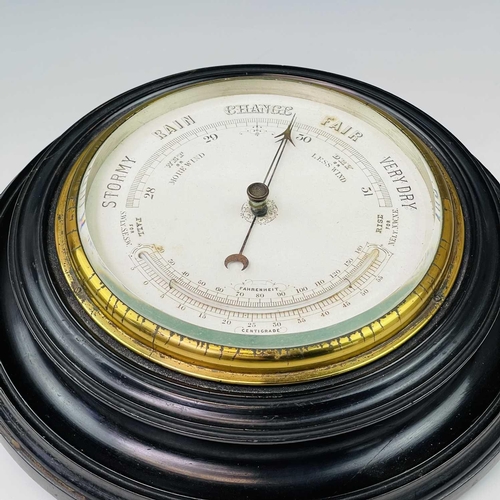 2907 - A late Victorian aneroid circular barometer, with white ceramic dial and ebonised case, diameter 28c... 