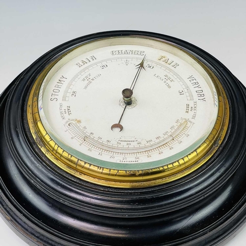2907 - A late Victorian aneroid circular barometer, with white ceramic dial and ebonised case, diameter 28c... 