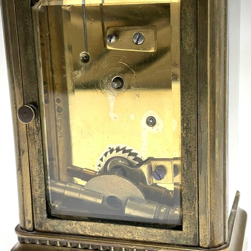 2909 - A late 19th century French brass carriage timepiece with Arabic numerals on an enamel ring face with... 