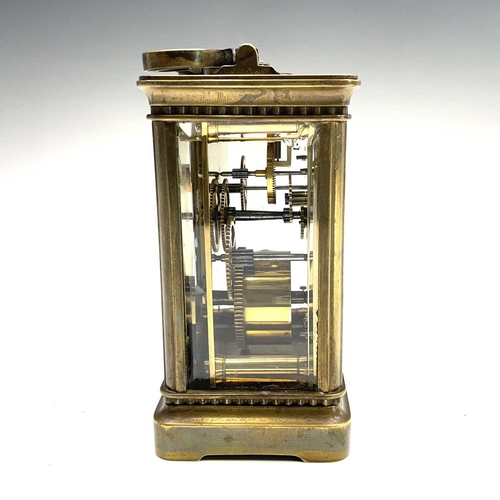 2909 - A late 19th century French brass carriage timepiece with Arabic numerals on an enamel ring face with... 