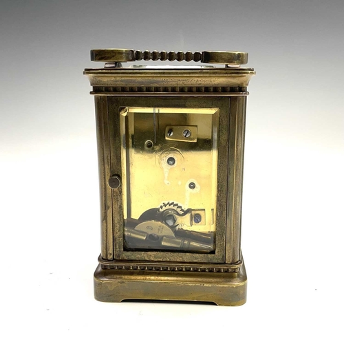 2909 - A late 19th century French brass carriage timepiece with Arabic numerals on an enamel ring face with... 