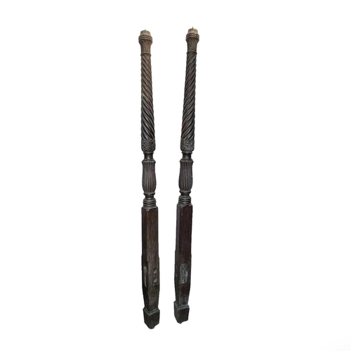 3001 - A pair of late George III mahogany bedposts, each with spiral turned, leaf carved and fluted decorat... 