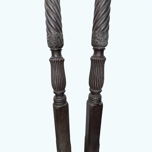 3001 - A pair of late George III mahogany bedposts, each with spiral turned, leaf carved and fluted decorat... 