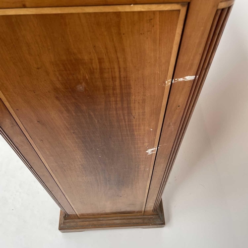 3002 - An Arts and crafts Cotswold school walnut glazed bookcase, the sycamore banded top with rounded corn... 