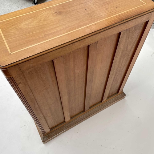 3002 - An Arts and crafts Cotswold school walnut glazed bookcase, the sycamore banded top with rounded corn... 