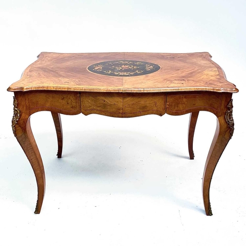 3004 - A Late Victorian walnut marquetry and brass mounted shaped table, the inlaid central decoration of s... 