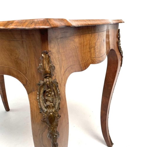 3004 - A Late Victorian walnut marquetry and brass mounted shaped table, the inlaid central decoration of s... 