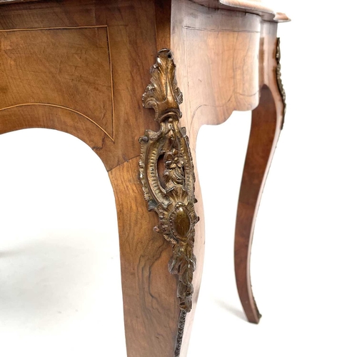 3004 - A Late Victorian walnut marquetry and brass mounted shaped table, the inlaid central decoration of s... 