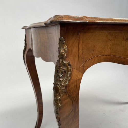 3004 - A Late Victorian walnut marquetry and brass mounted shaped table, the inlaid central decoration of s... 