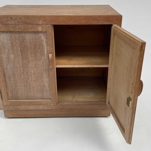 3008 - A Heal's type limed oak two door cupboard on castor wheels, signed and dated in pencil to interior R... 