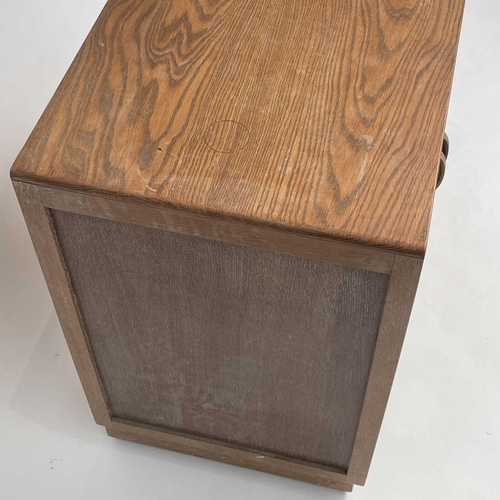 3008 - A Heal's type limed oak two door cupboard on castor wheels, signed and dated in pencil to interior R... 