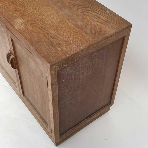 3008 - A Heal's type limed oak two door cupboard on castor wheels, signed and dated in pencil to interior R... 