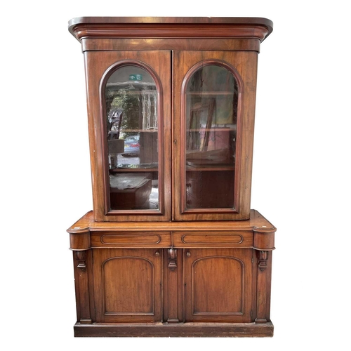 3010 - A Victorian mahogany bookcase with moulded cornice, glazed twin doors enclosing three adjustable she... 