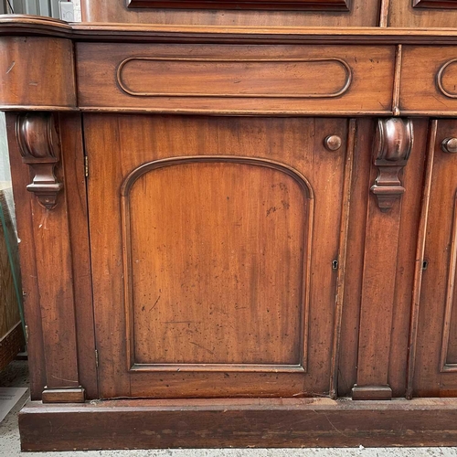 3010 - A Victorian mahogany bookcase with moulded cornice, glazed twin doors enclosing three adjustable she... 
