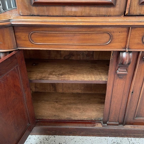 3010 - A Victorian mahogany bookcase with moulded cornice, glazed twin doors enclosing three adjustable she... 
