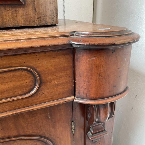 3010 - A Victorian mahogany bookcase with moulded cornice, glazed twin doors enclosing three adjustable she... 