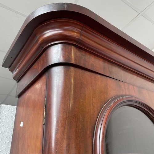 3010 - A Victorian mahogany bookcase with moulded cornice, glazed twin doors enclosing three adjustable she... 