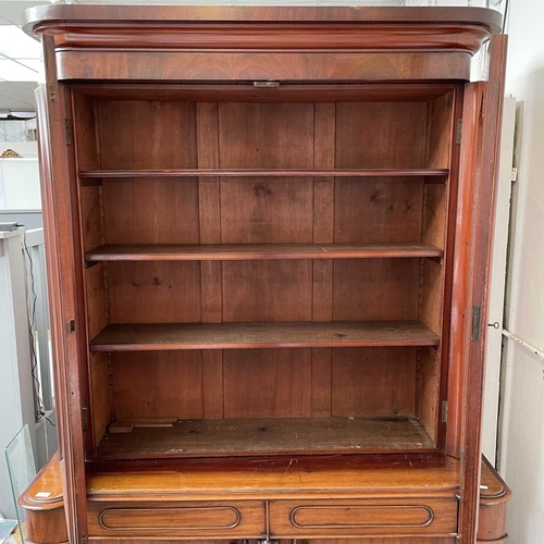 3010 - A Victorian mahogany bookcase with moulded cornice, glazed twin doors enclosing three adjustable she... 