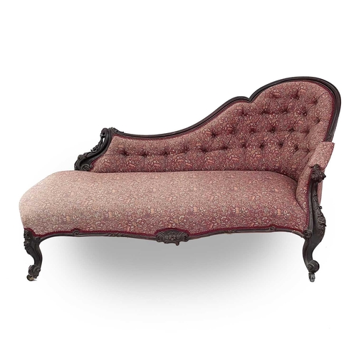 3014 - A Victorian mahogany chaise longue, the moulded and shaped back with floral and foliate carved decor... 