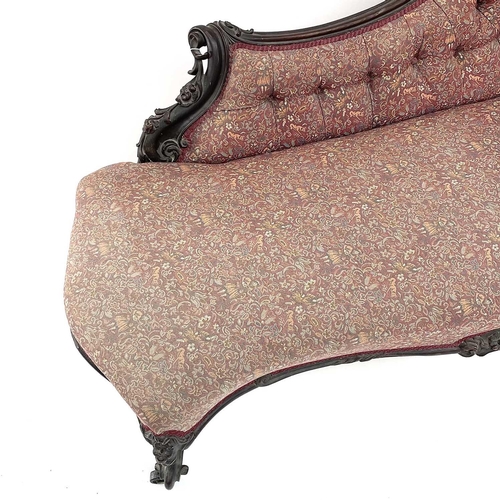 3014 - A Victorian mahogany chaise longue, the moulded and shaped back with floral and foliate carved decor... 