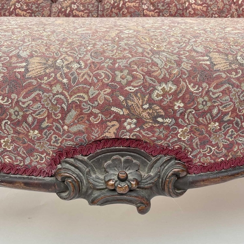 3014 - A Victorian mahogany chaise longue, the moulded and shaped back with floral and foliate carved decor... 