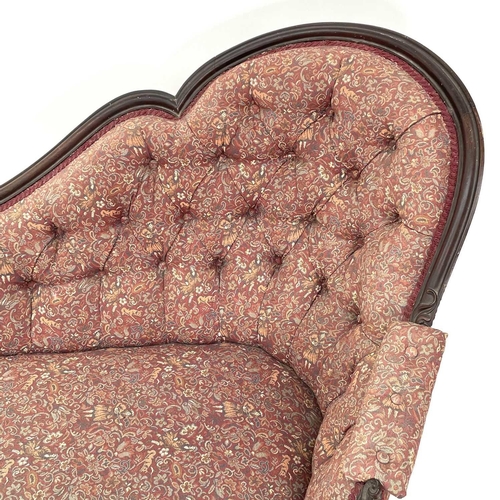 3014 - A Victorian mahogany chaise longue, the moulded and shaped back with floral and foliate carved decor... 