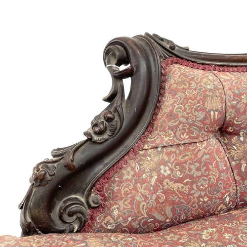 3014 - A Victorian mahogany chaise longue, the moulded and shaped back with floral and foliate carved decor... 