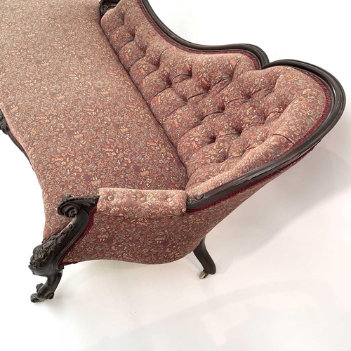 3014 - A Victorian mahogany chaise longue, the moulded and shaped back with floral and foliate carved decor... 