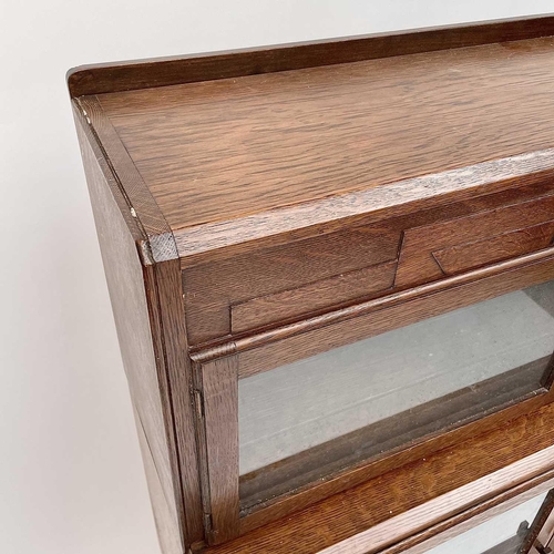 3019 - A pair of oak sectional bookcases, the 1930s, each with Odeonesque moulded frieze above two pairs of... 