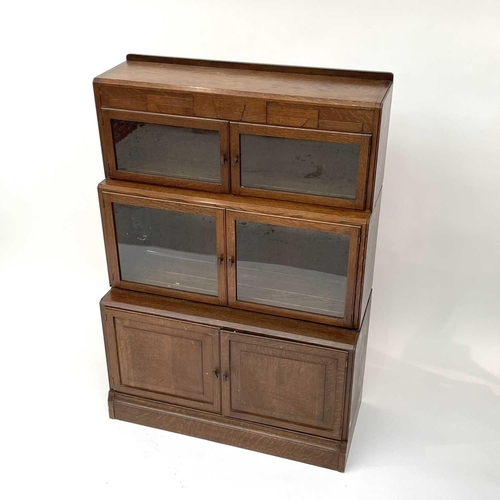 3019 - A pair of oak sectional bookcases, the 1930s, each with Odeonesque moulded frieze above two pairs of... 
