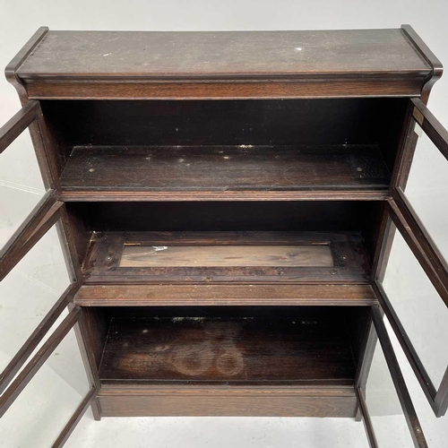 3020 - An oak sectional bookcase, 1930s, the three parts each with twin glazed hinged doors, height 119cm, ... 