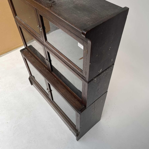 3020 - An oak sectional bookcase, 1930s, the three parts each with twin glazed hinged doors, height 119cm, ... 