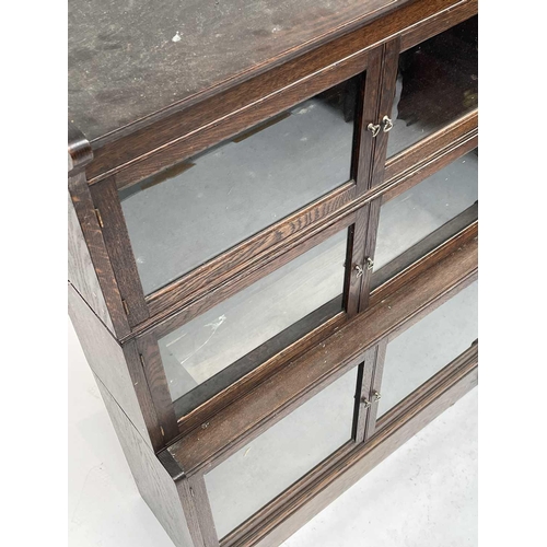 3020 - An oak sectional bookcase, 1930s, the three parts each with twin glazed hinged doors, height 119cm, ... 