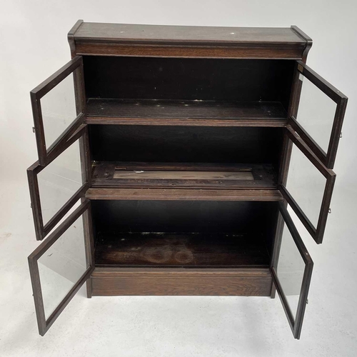 3020 - An oak sectional bookcase, 1930s, the three parts each with twin glazed hinged doors, height 119cm, ... 