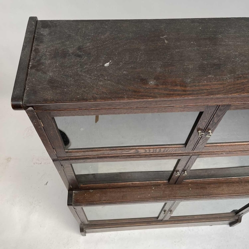 3020 - An oak sectional bookcase, 1930s, the three parts each with twin glazed hinged doors, height 119cm, ... 