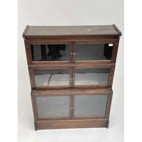 3020 - An oak sectional bookcase, 1930s, the three parts each with twin glazed hinged doors, height 119cm, ... 