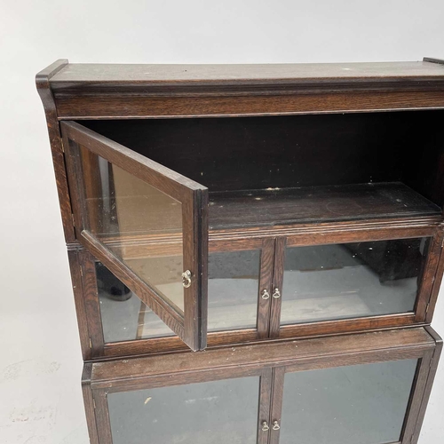 3020 - An oak sectional bookcase, 1930s, the three parts each with twin glazed hinged doors, height 119cm, ... 