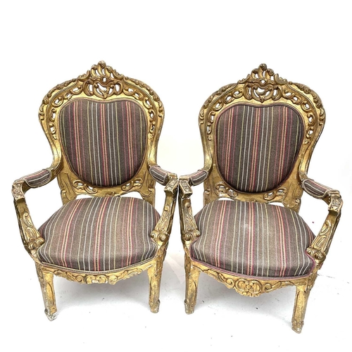 3133 - A pair of early 20th century French giltwood armchairs carved with scrolls and flowers, height 118cm... 