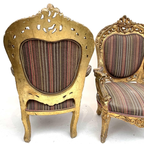 3133 - A pair of early 20th century French giltwood armchairs carved with scrolls and flowers, height 118cm... 