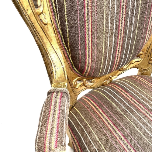 3133 - A pair of early 20th century French giltwood armchairs carved with scrolls and flowers, height 118cm... 