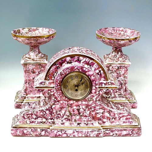 845 - A French pink lustre three-piece clock set, circa 1920, with mottled splash decoration, with two cla... 
